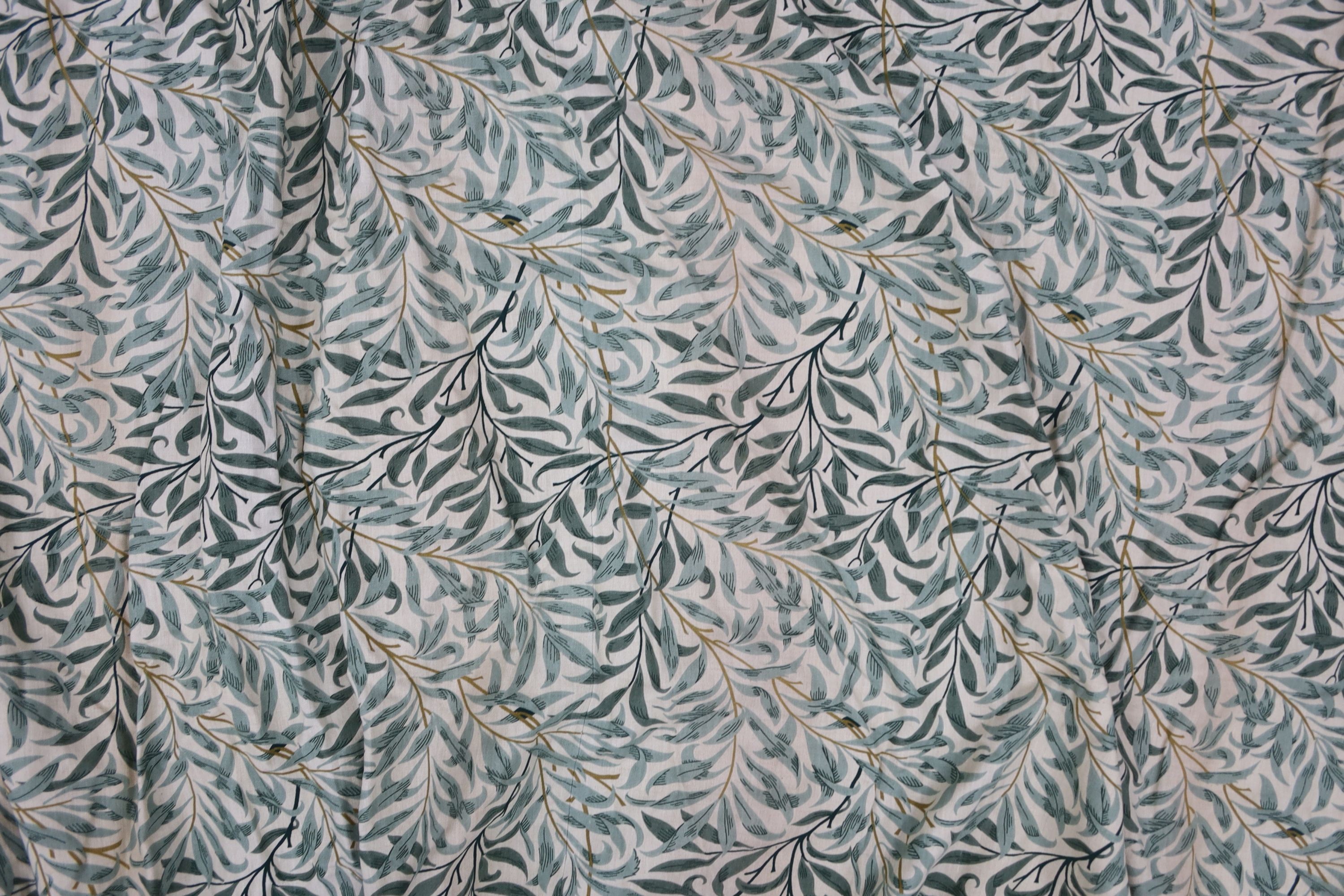 A pair of linen, 'Morris' style curtains and another pair of cotton curtains with a pineapple design